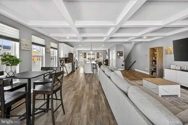 a kitchen with stainless steel appliances kitchen island granite countertop a stove a sink a refrigerator and cabinets