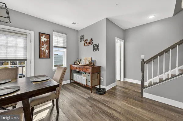 a spacious bedroom with a bed and a flat tv screen on dresser