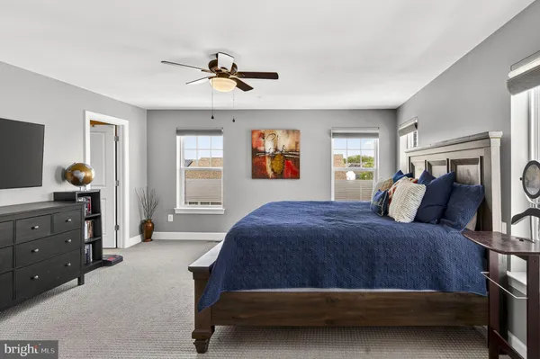 a bed room with bed and windows