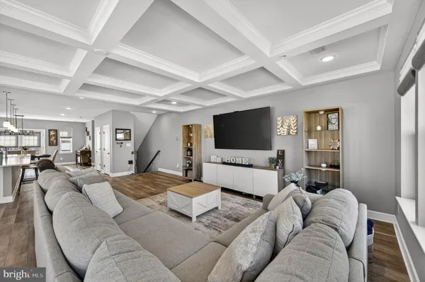 a living room with furniture wooden floor and a flat screen tv