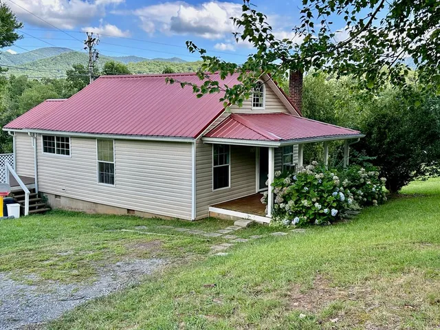 a view of a house with a yard and sitting area