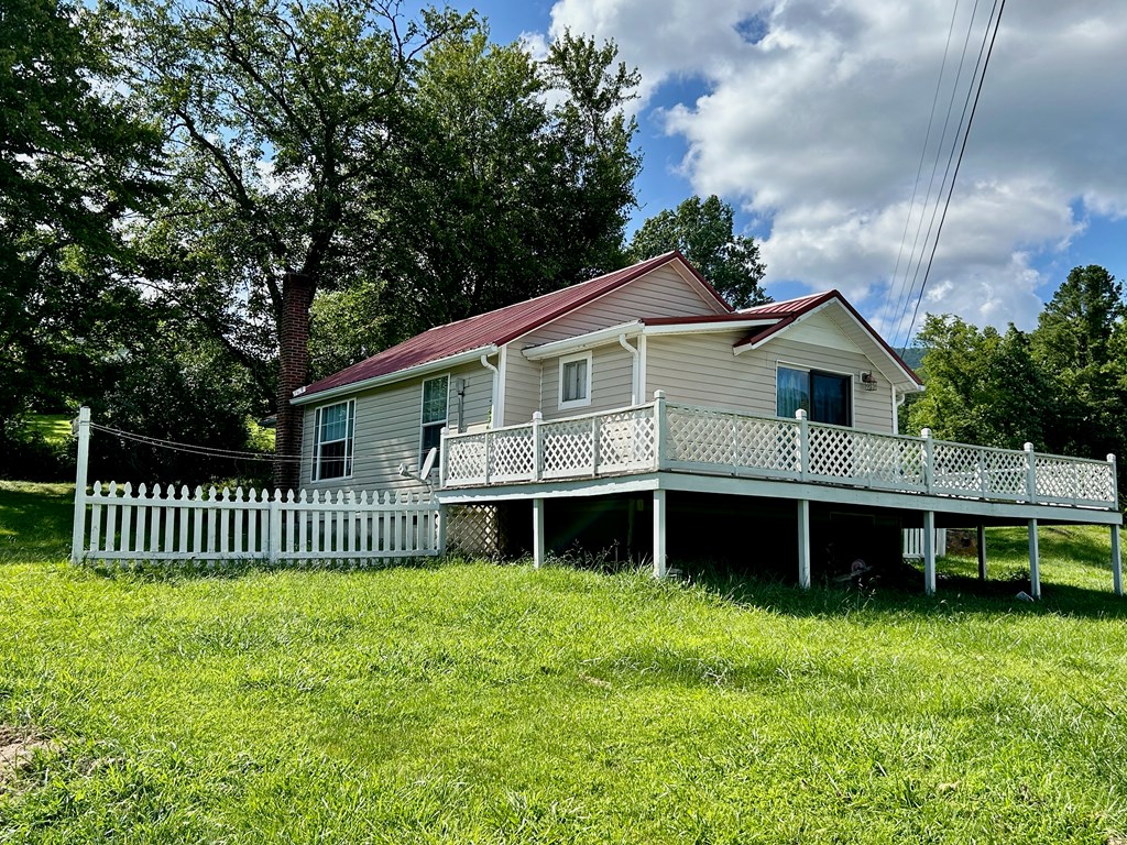 136 West Vineyard Road Hayesville, NC 28904 - Photo 11 of 17 a front view of a house with a garden