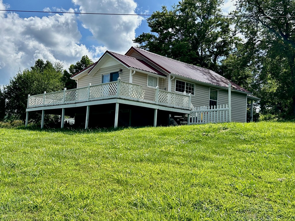 136 West Vineyard Road Hayesville, NC 28904 - Photo 12 of 17 a front view of a house with a garden