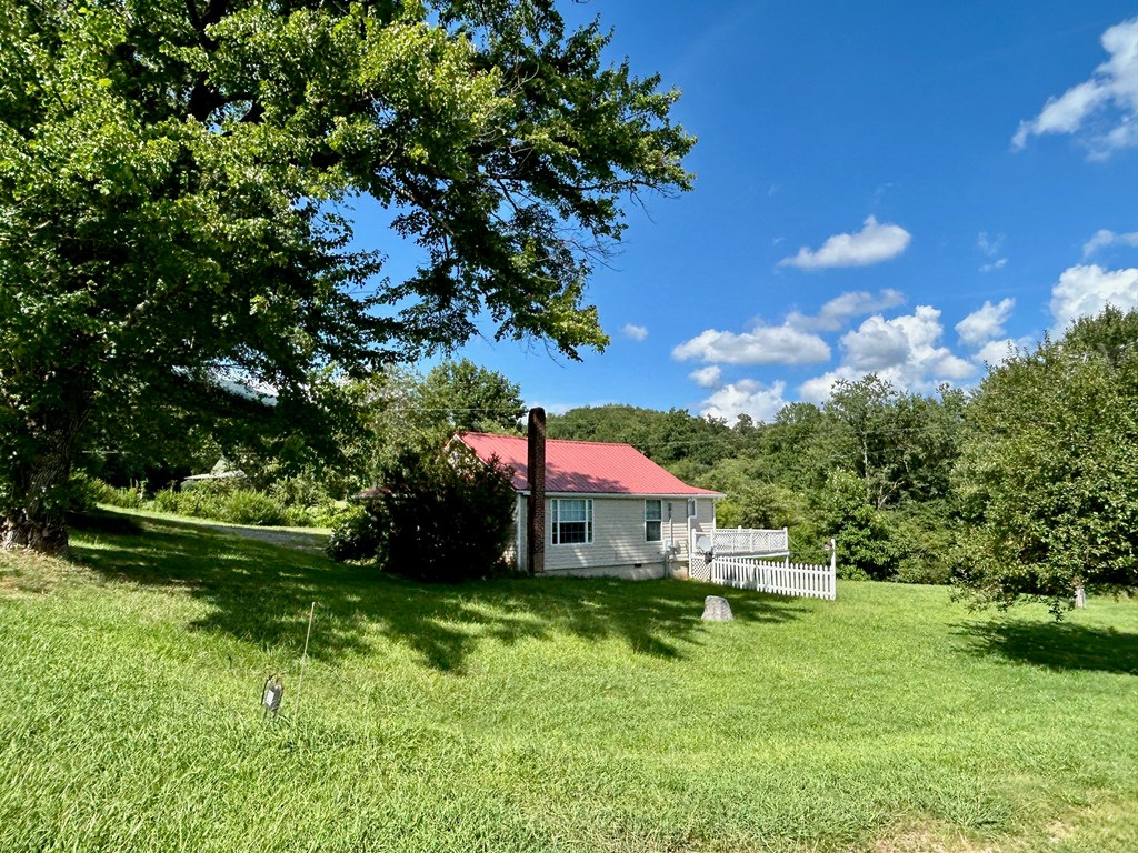 136 West Vineyard Road Hayesville, NC 28904 - Photo 13 of 17 a view of backyard with table and chairs and potted plants and large trees