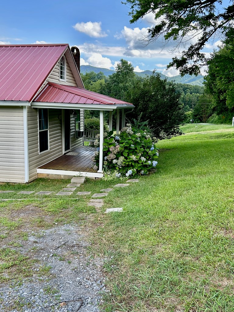 136 West Vineyard Road Hayesville, NC 28904 - Photo 16 of 17 a front view of a house with garden