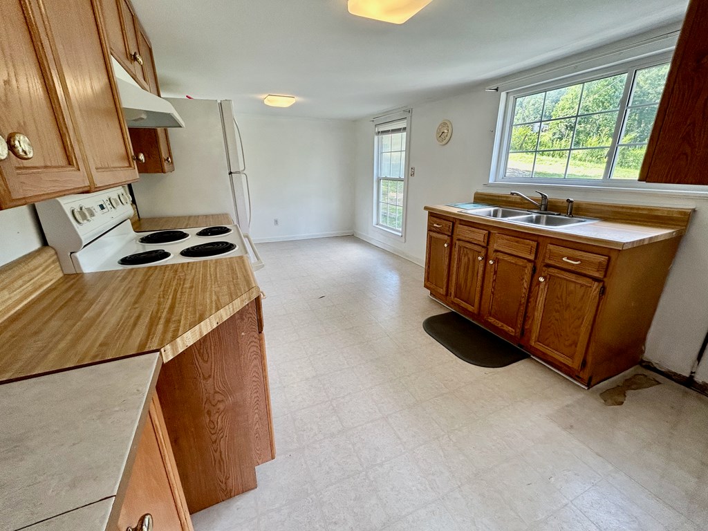 136 West Vineyard Road Hayesville, NC 28904 - Photo 10 of 17 a kitchen with stainless steel appliances granite countertop a stove a sink and a microwave