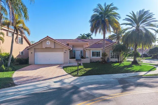 a view of a house with a yard and sitting area