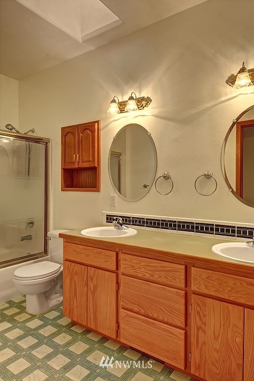 20223 Southeast 152nd Street Renton, WA 98059 - Photo 14 of 18 a bathroom with a toilet sink mirror vanity and shower