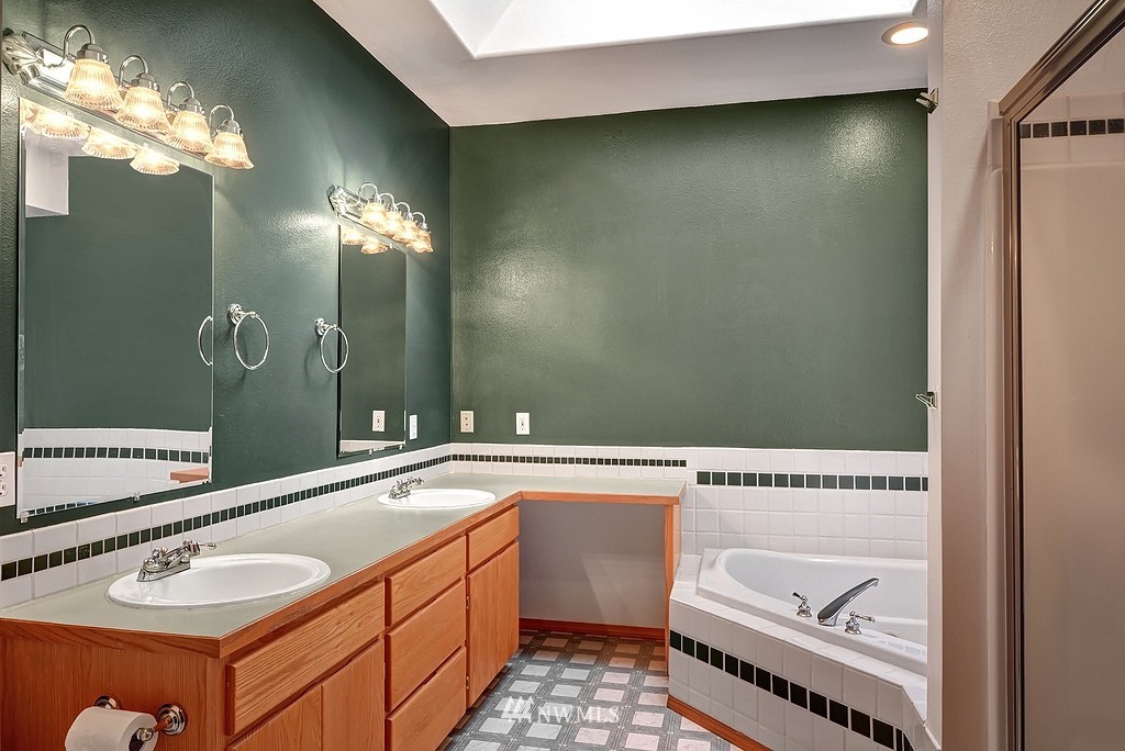 20223 Southeast 152nd Street Renton, WA 98059 - Photo 16 of 18 a spacious bathroom with a granite countertop sink and a mirror
