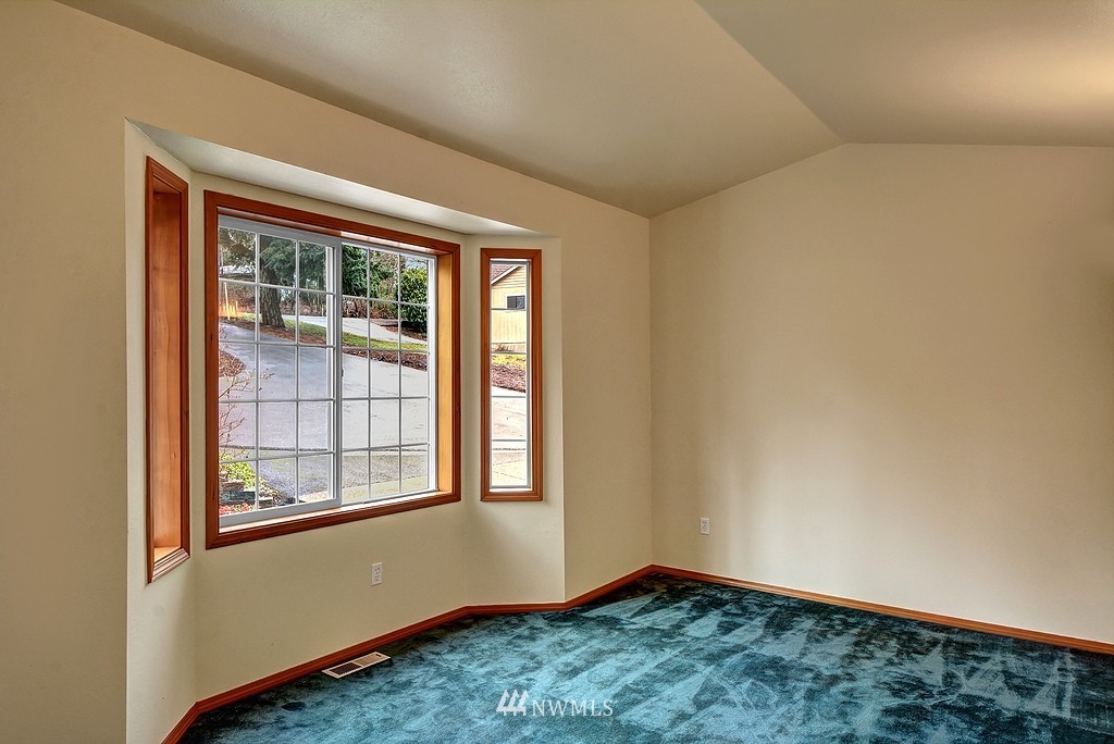 20223 Southeast 152nd Street Renton, WA 98059 - Photo 10 of 18 an empty room with wooden floor and windows