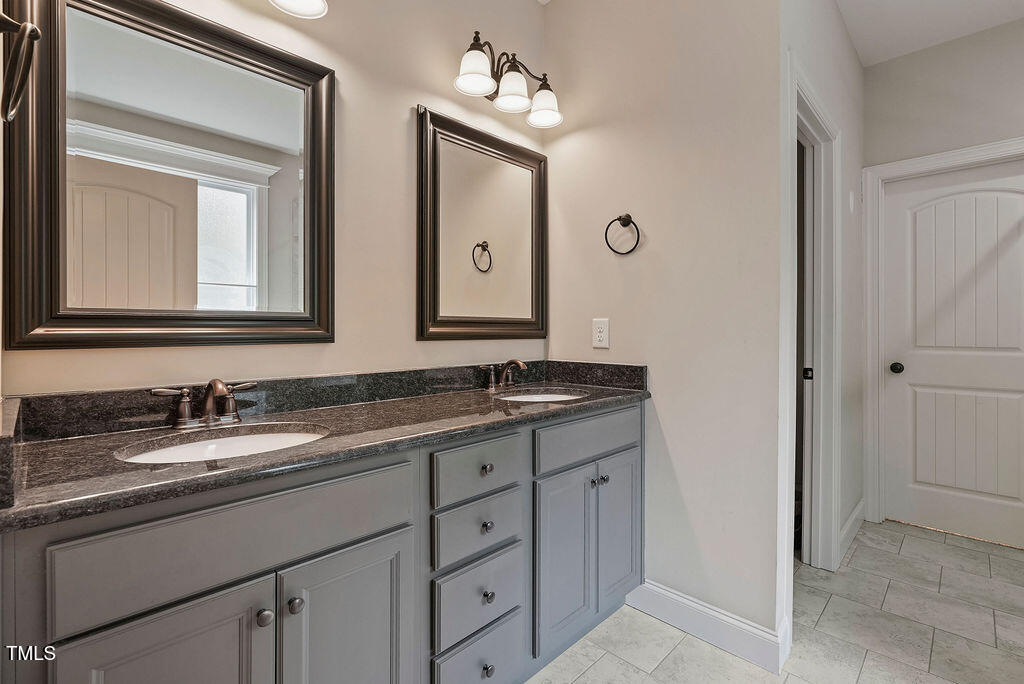 1124 Armsleigh Court Raleigh, NC 27603 - Photo 17 of 33 a bathroom with 2 sink and a mirror