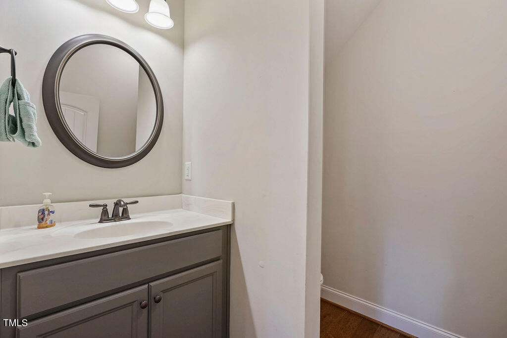 1124 Armsleigh Court Raleigh, NC 27603 - Photo 22 of 33 a bathroom with a sink and a mirror