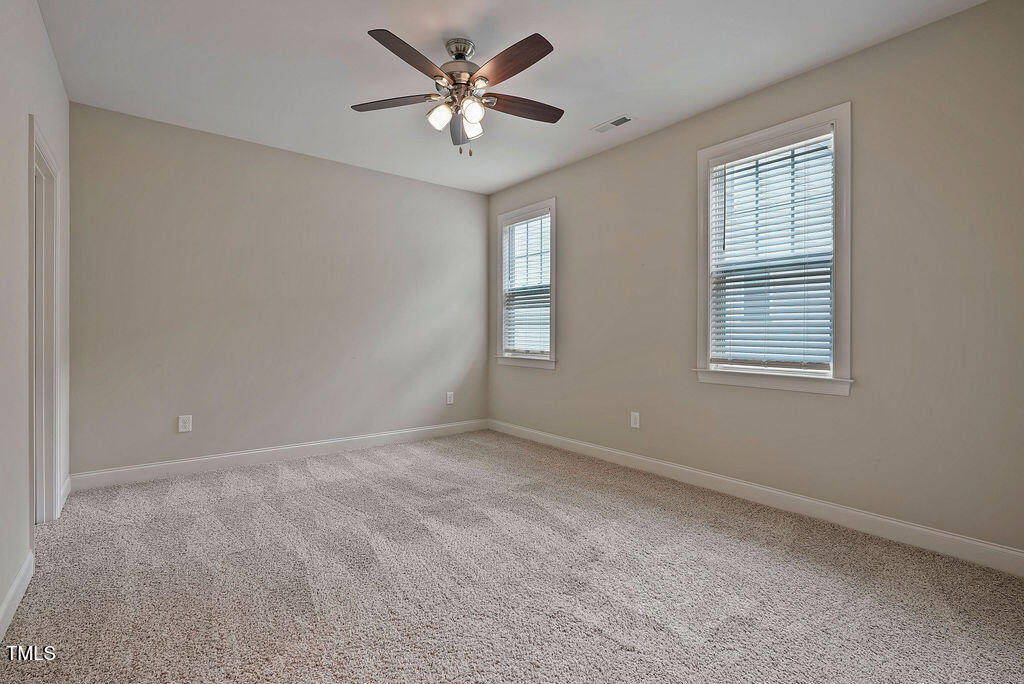 1124 Armsleigh Court Raleigh, NC 27603 - Photo 24 of 33 an empty room with windows and fan