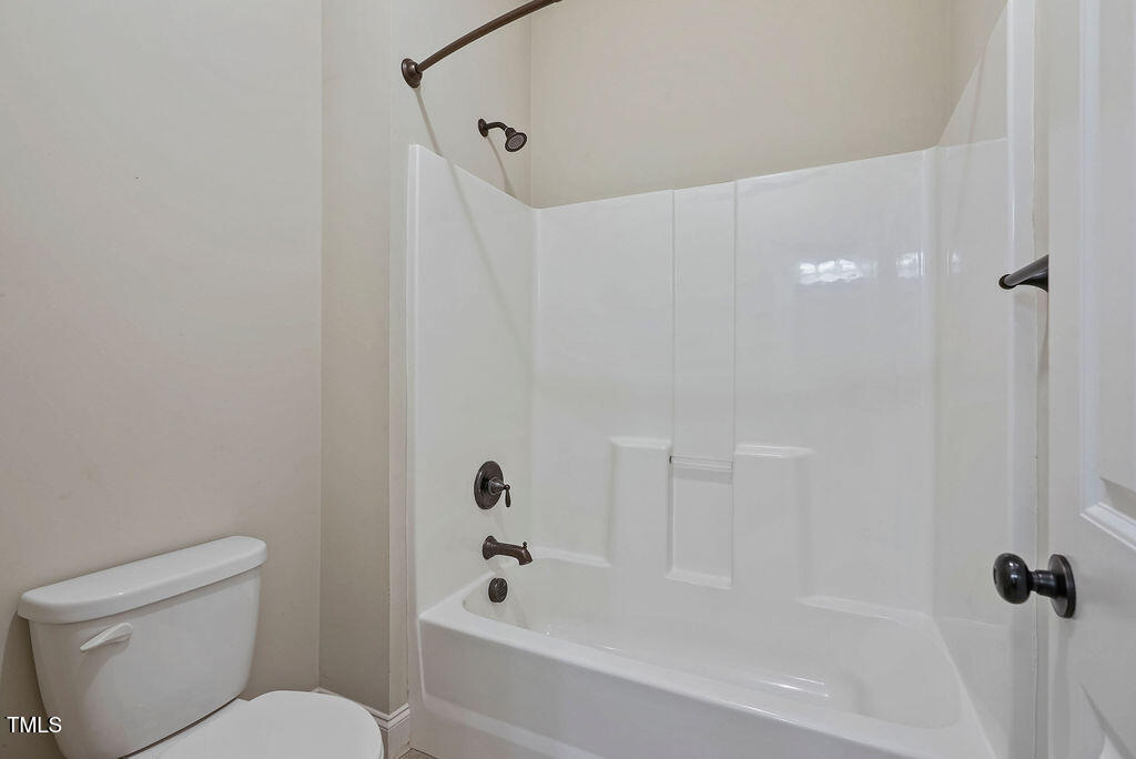 1124 Armsleigh Court Raleigh, NC 27603 - Photo 30 of 33 a white bath tub sitting next to a white toilet