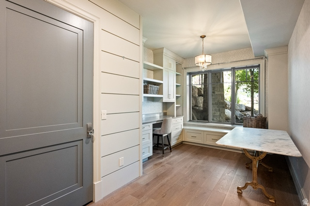 3 Carriagewood Cove, Unit 1088 Sandy, UT 84092 - Photo 48 of 79 Built-in desk and cabinetry with window seating, shiplap wall accents, wood-finish flooring, and a marble-top table