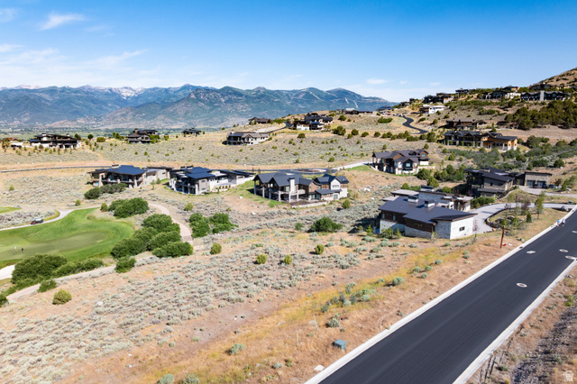 2712 East Boulder Top Loop, Unit 583 Heber City, UT 84032 - Photo 8 of 17 Expansive residential development featuring modern architecture, mountain backdrop, paved roadways, and proximity to a golf course