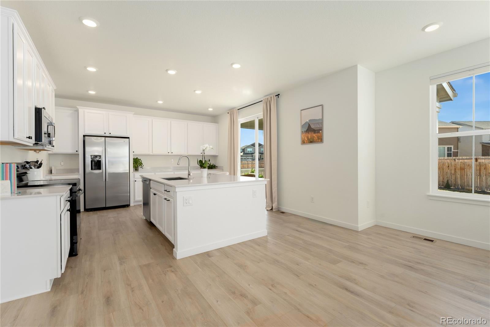 817 S Flat Aurora, CO 80018 - Photo 14 of 41 a view of kitchen with refrigerator cabinets and wooden floor