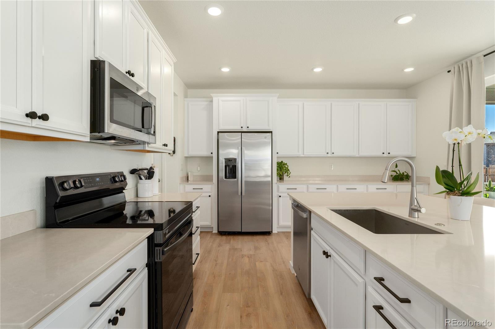 817 S Flat Aurora, CO 80018 - Photo 15 of 41 a kitchen with a sink a stove and refrigerator