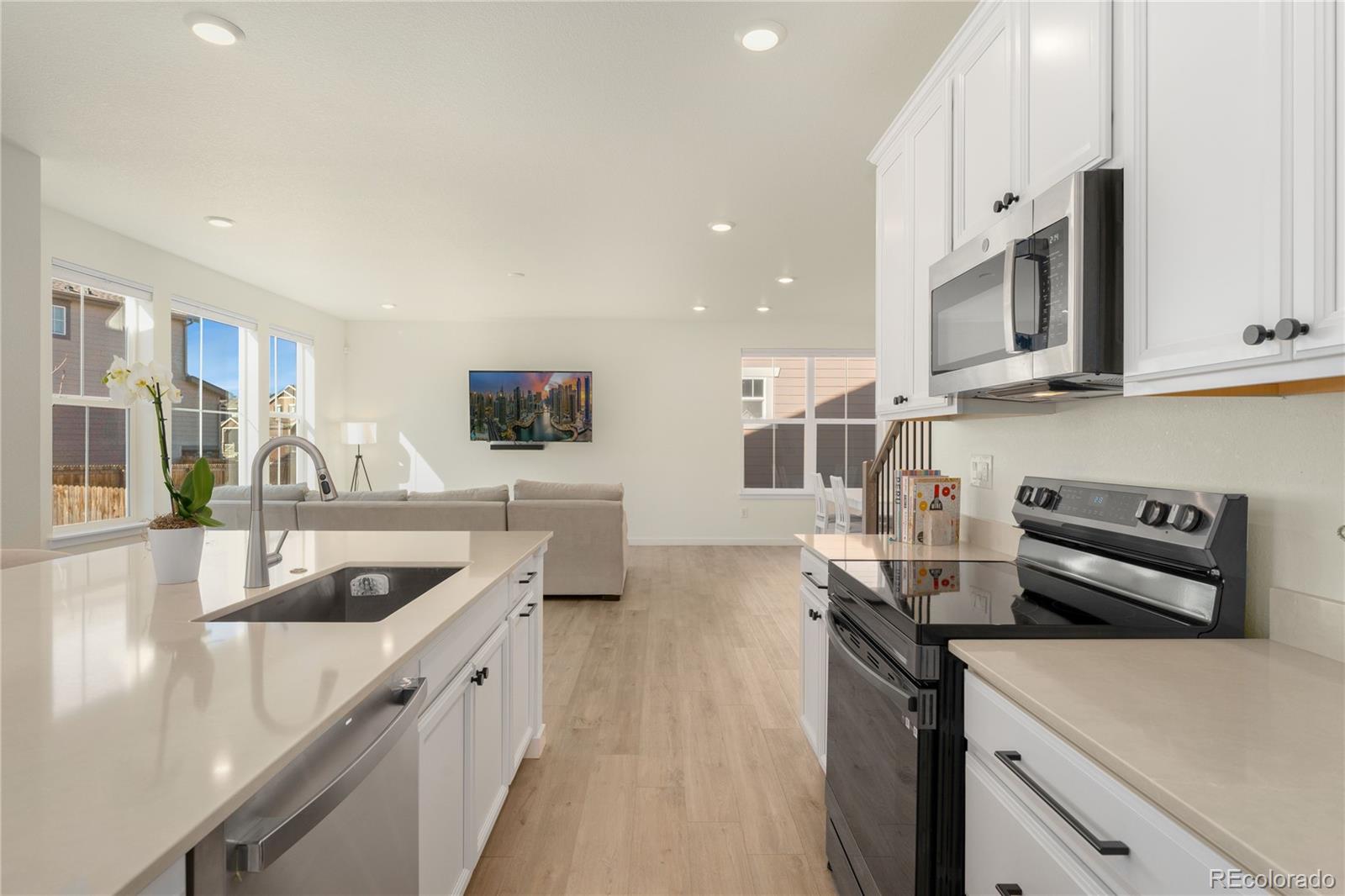 817 S Flat Aurora, CO 80018 - Photo 16 of 41 a kitchen with stainless steel appliances granite countertop a sink and a stove