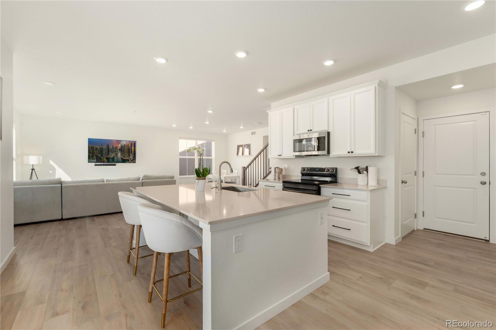 817 S Flat Aurora, CO 80018 - Photo 17 of 41 a kitchen with stainless steel appliances kitchen island granite countertop a sink and cabinets