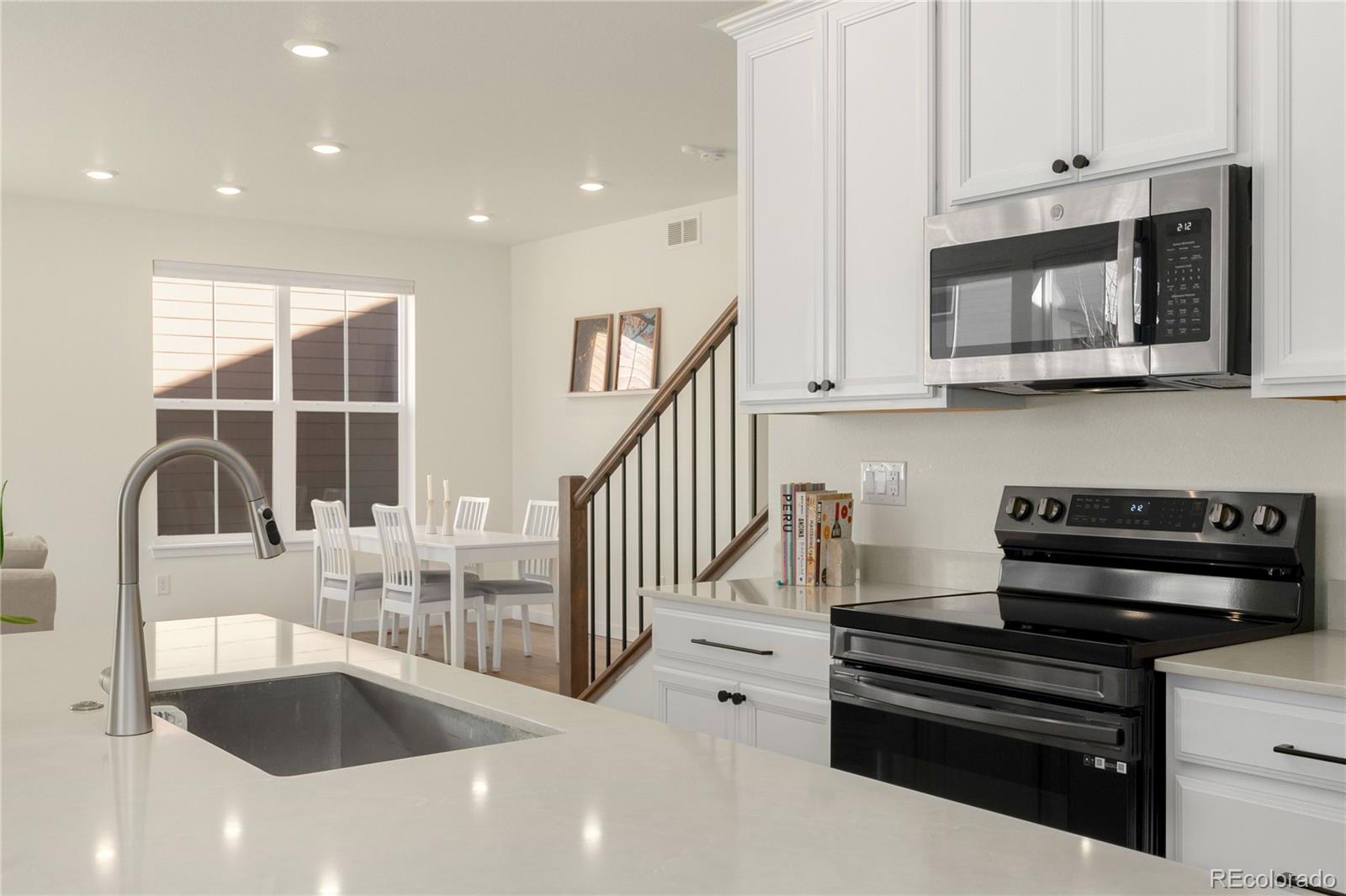 817 S Flat Aurora, CO 80018 - Photo 19 of 41 a kitchen with granite countertop a stove and a sink