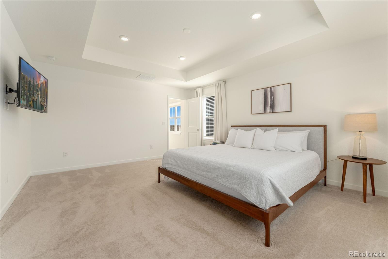 817 S Flat Aurora, CO 80018 - Photo 28 of 41 a spacious bedroom with a bed and a tv