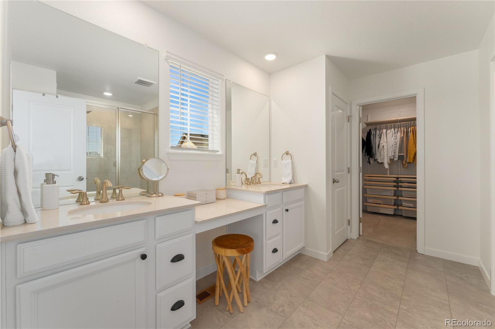 817 S Flat Aurora, CO 80018 - Photo 30 of 41 a spacious bathroom with a double vanity sink a mirror and a bathtub