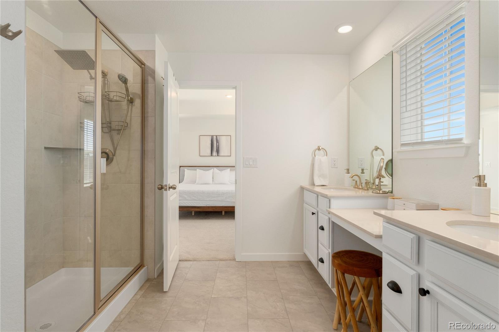 817 S Flat Aurora, CO 80018 - Photo 32 of 41 a spacious bathroom with a shower sink and a mirror