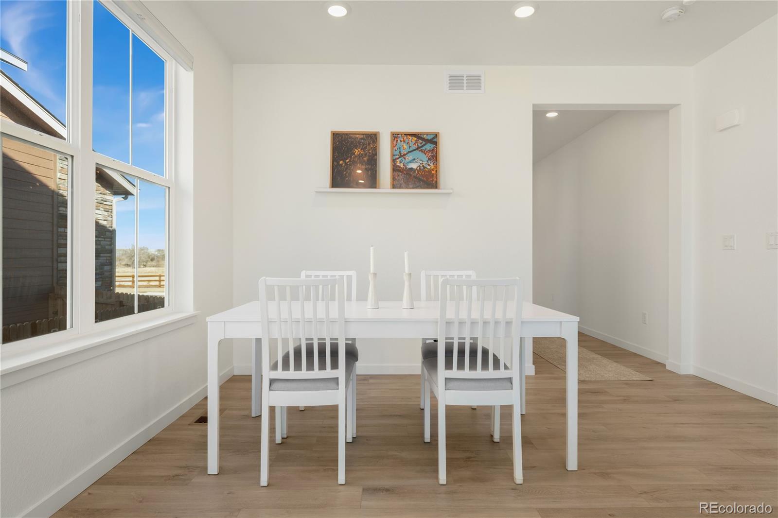 817 S Flat Aurora, CO 80018 - Photo 9 of 41 a view of a dining room with chairs and wooden floor