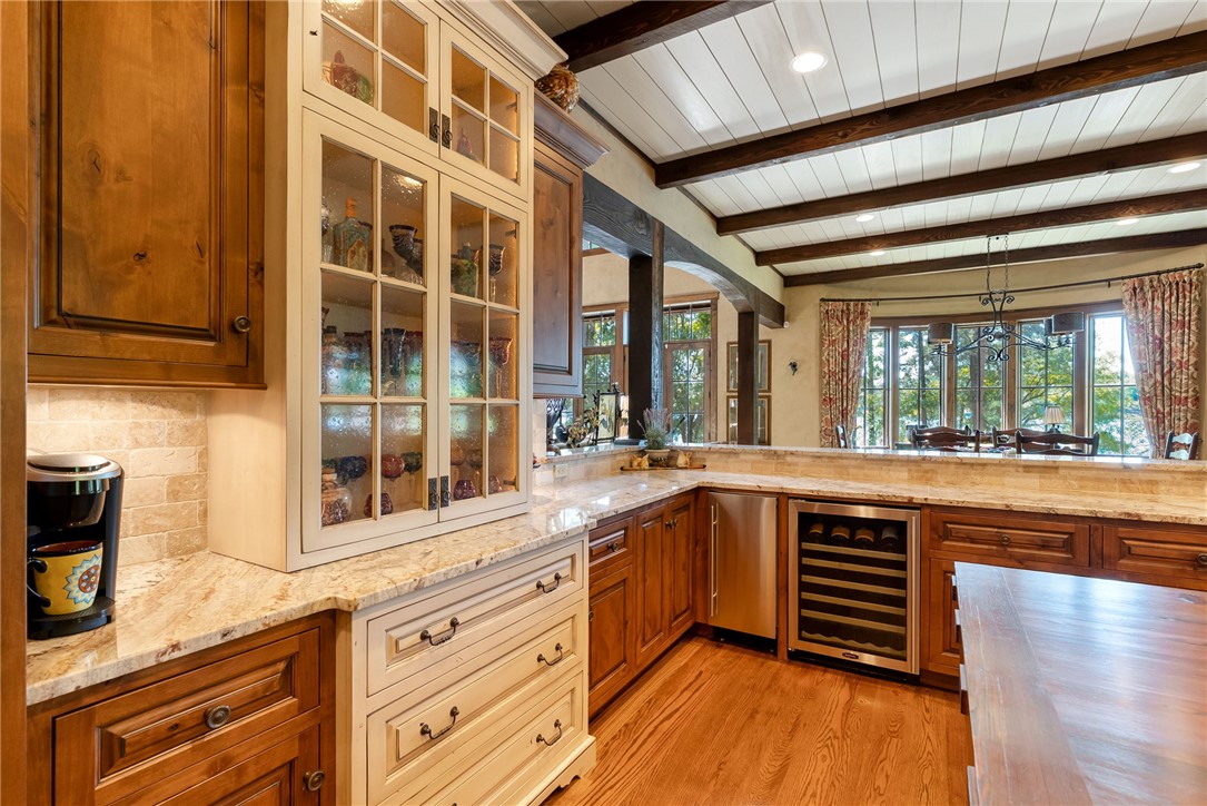 104 Crooked Stick Court Sunset, SC 29685 - Photo 11 of 43 This spacious kitchen features warm wood cabinetry, granite countertops, and elegant beamed ceilings.