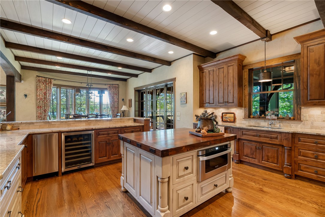 104 Crooked Stick Court Sunset, SC 29685 - Photo 12 of 43 This spacious kitchen boasts elegant wood flooring and exposed beam ceilings.