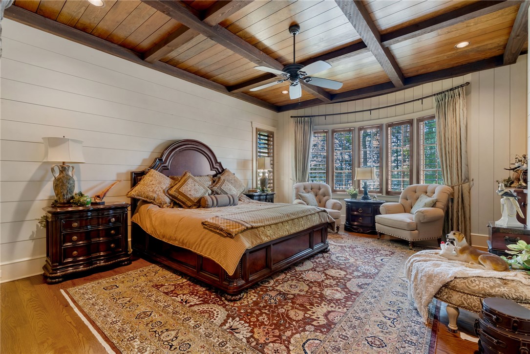 104 Crooked Stick Court Sunset, SC 29685 - Photo 17 of 43 This spacious primary bedroom offers comfort with high ceilings and rich wood flooring.