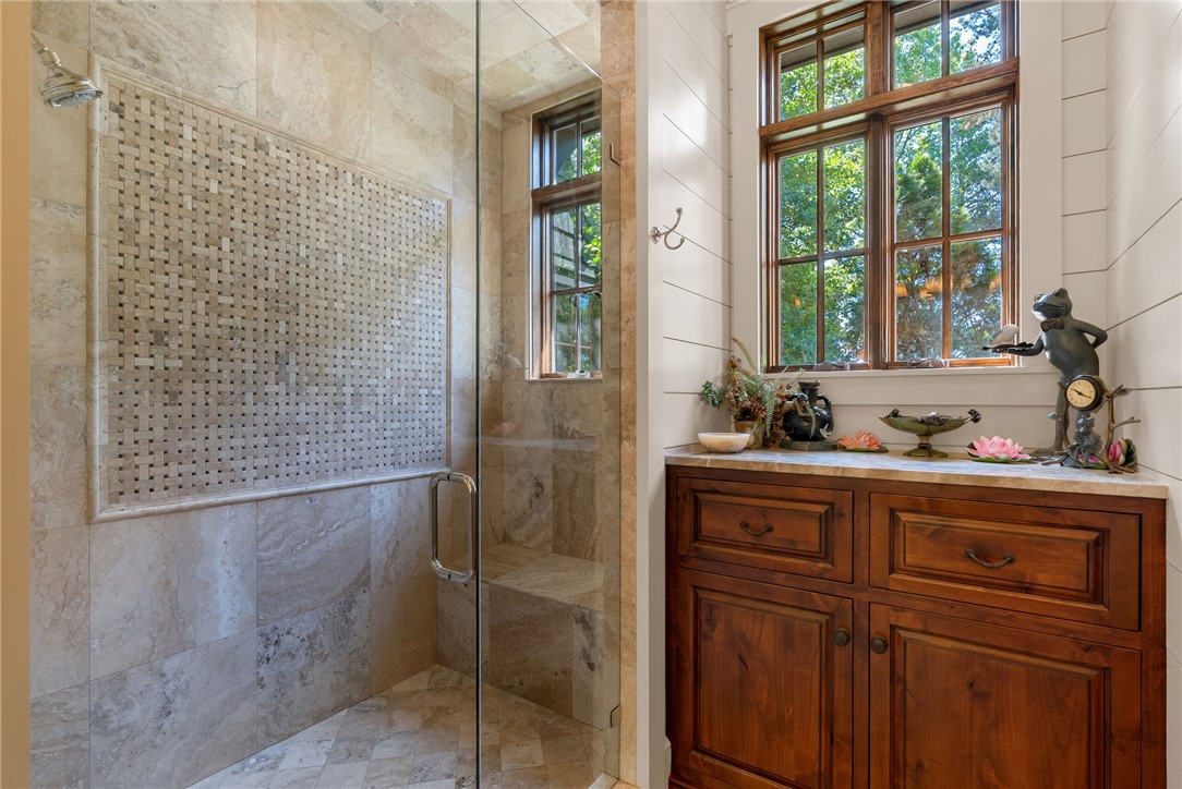 104 Crooked Stick Court Sunset, SC 29685 - Photo 19 of 43 This bathroom features a spacious shower and a charming wooden vanity with ample storage.