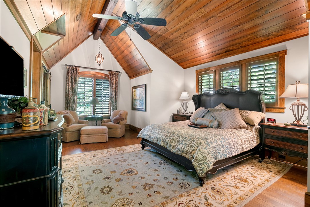 104 Crooked Stick Court Sunset, SC 29685 - Photo 25 of 43 This primary bedroom features high vaulted ceilings with natural wood, creating an airy and inviting retreat.