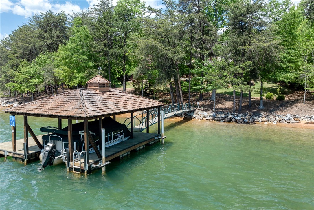 104 Crooked Stick Court Sunset, SC 29685 - Photo 31 of 43 This serene lakefront property boasts a covered boat dock, providing seamless water access.