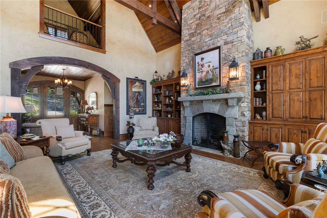 104 Crooked Stick Court Sunset, SC 29685 - Photo 4 of 43 This grand living room features a soaring vaulted ceiling and a stately stone fireplace, creating an inviting atmosphere.