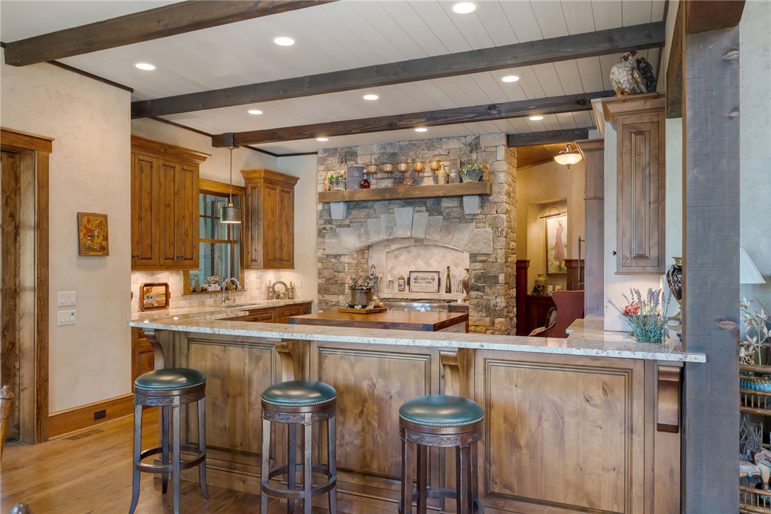 104 Crooked Stick Court Sunset, SC 29685 - Photo 7 of 43 This spacious kitchen offers ample counter space and exposed beam details.