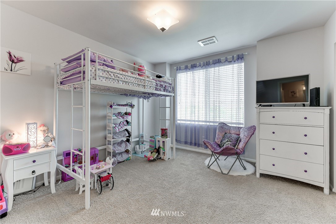 3337 30th Drive Everett, WA 98201 - Photo 26 of 28 a bedroom with furniture a flat tv screen and a dresser