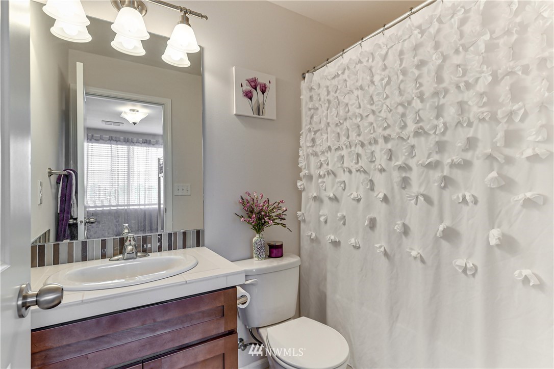 3337 30th Drive Everett, WA 98201 - Photo 28 of 28 a bathroom with a sink a toilet and a mirror