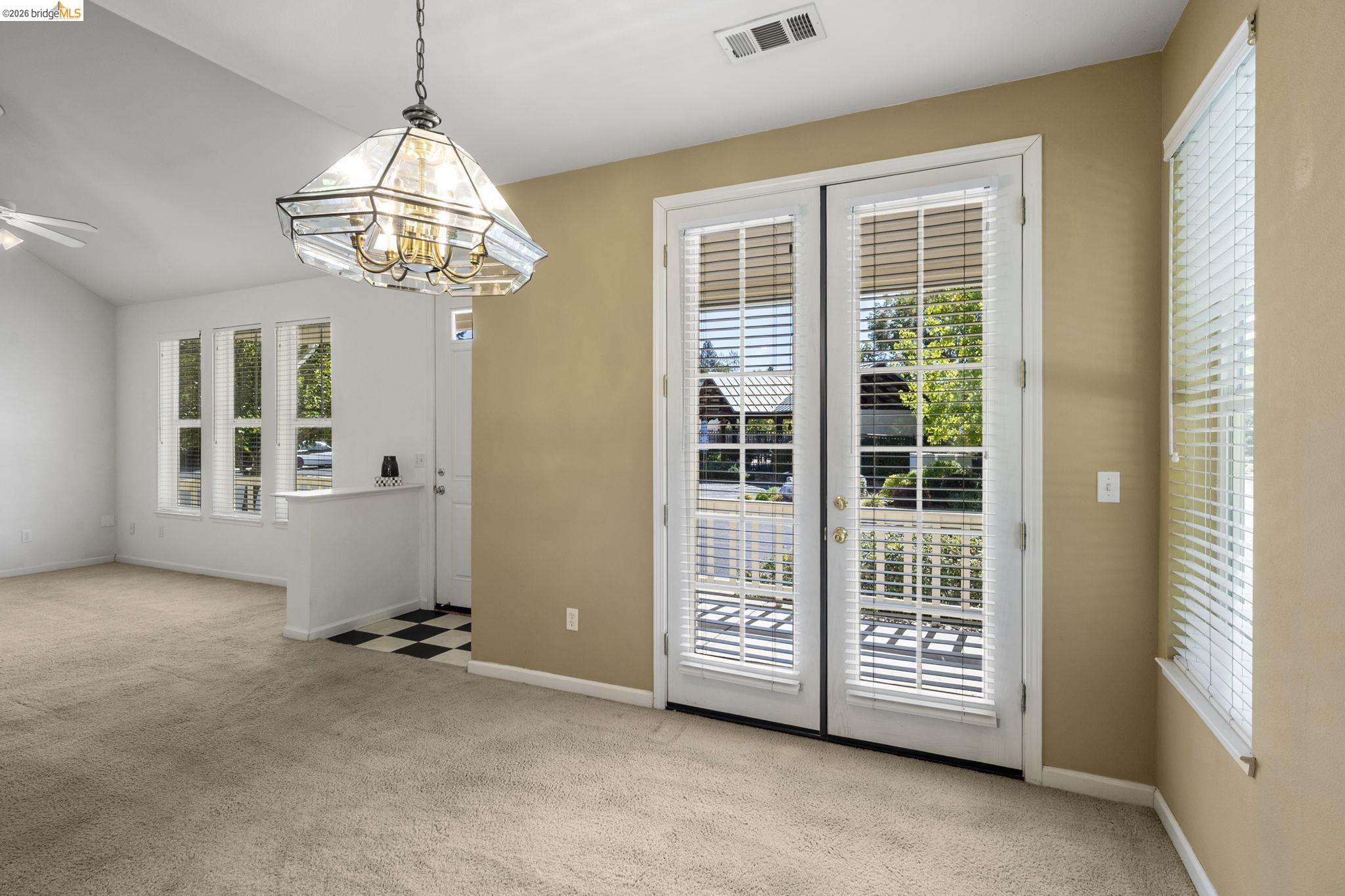 343 Field Stone Drive Murphys, CA 95247 - Photo 13 of 40 an empty room with windows and chandelier