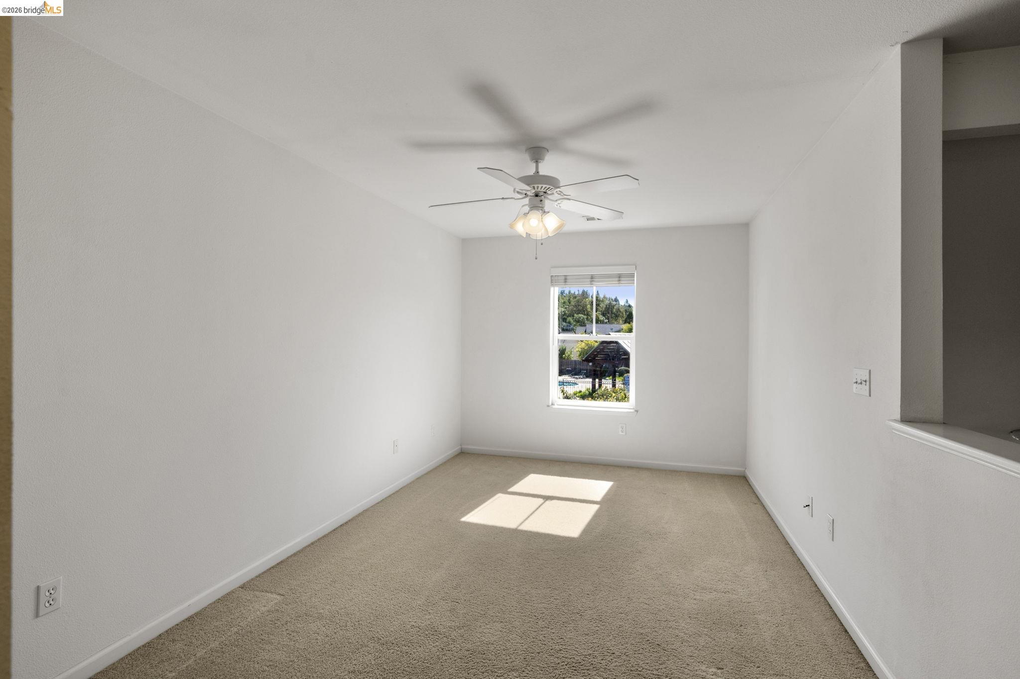 343 Field Stone Drive Murphys, CA 95247 - Photo 27 of 40 an empty room with windows and ceiling fan