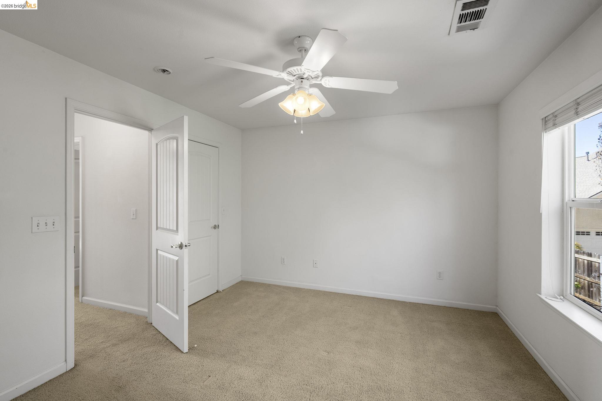 343 Field Stone Drive Murphys, CA 95247 - Photo 28 of 40 an empty room with windows and fan
