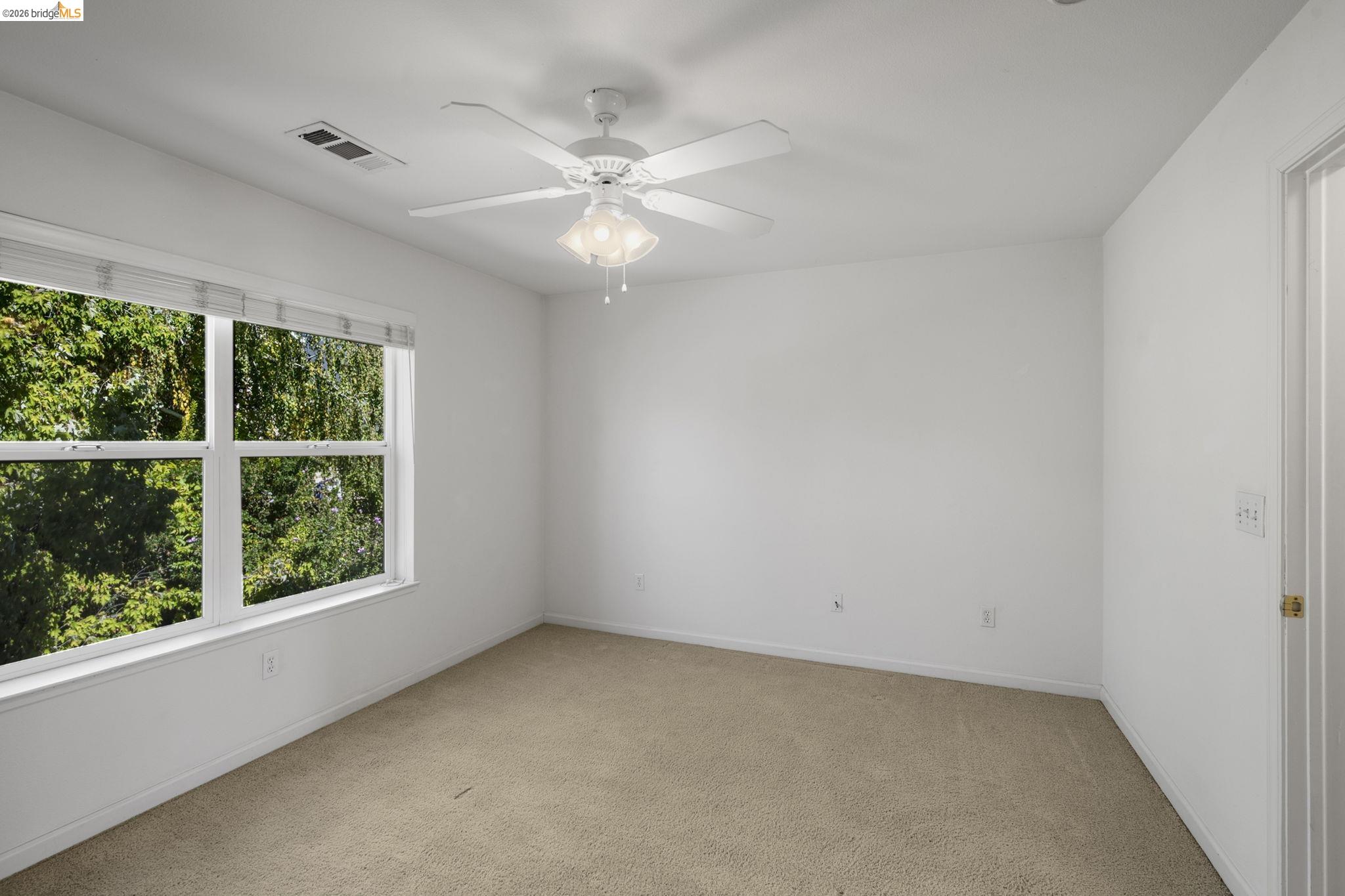343 Field Stone Drive Murphys, CA 95247 - Photo 29 of 40 an empty room with a window and a fan