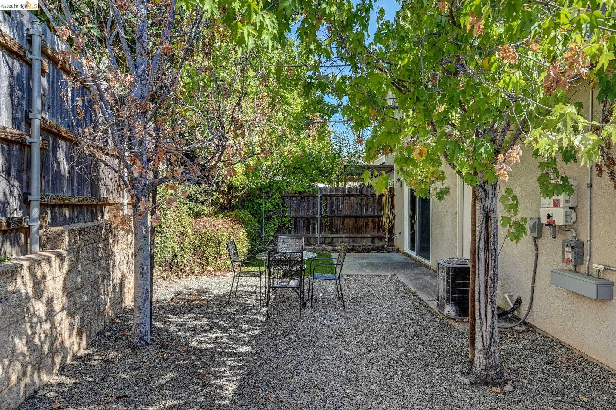 343 Field Stone Drive Murphys, CA 95247 - Photo 36 of 40 a view of a backyard with table and chairs and a large tree