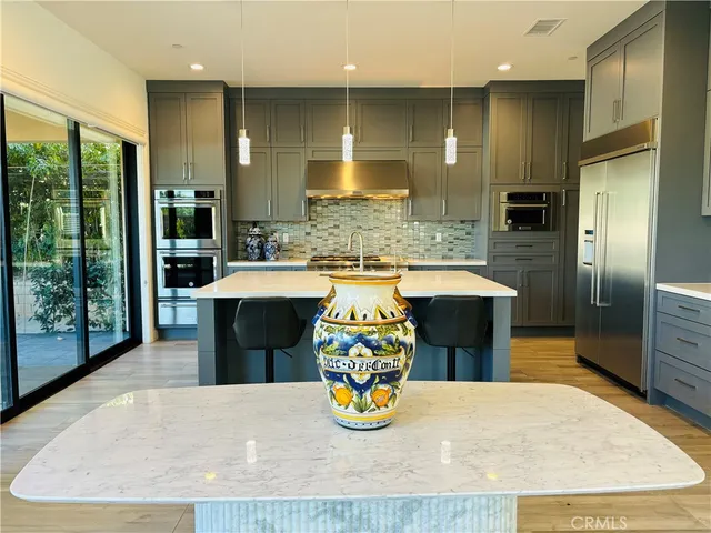 a kitchen with refrigerator and window