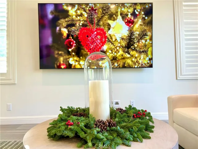 a kitchen with stainless steel appliances kitchen island granite countertop a refrigerator a sink a stove and a wooden floors