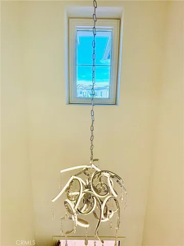 a large kitchen with stainless steel appliances a large counter top a refrigerator a sink and a stove with wooden floor