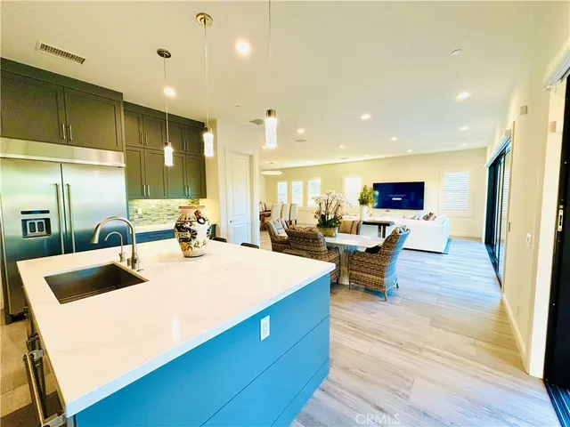 a living room with lots of furniture and kitchen view