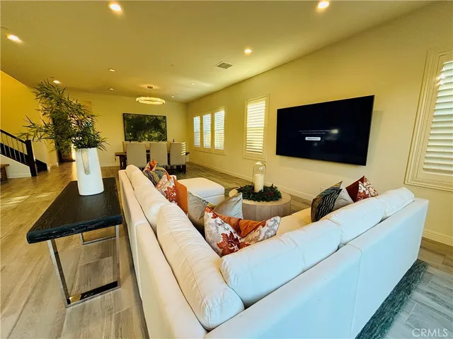 a living room with furniture and view of kitchen