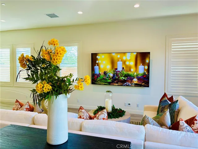 a living room with furniture and flowers